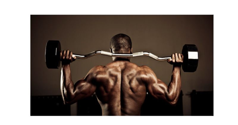 Ways to Tone Your Back - Man performing a military press
