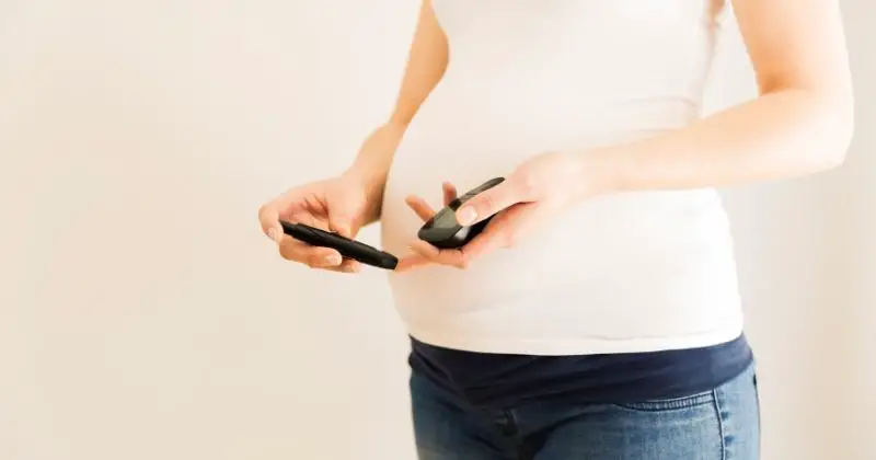 Prevent Gestational Diabetes - pregnant woman taking her blood sugar reding