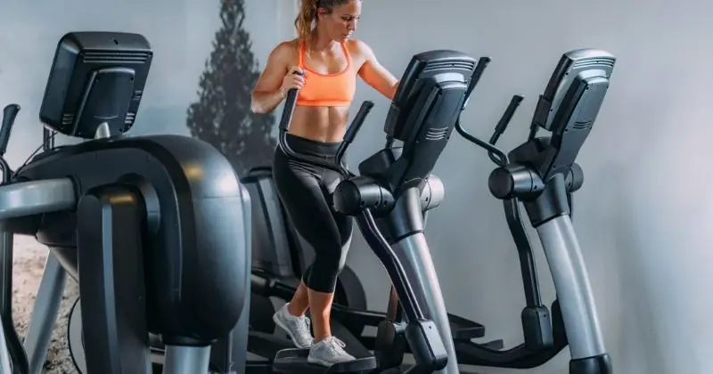 Home Gym Equipment - a woman using an elliptical