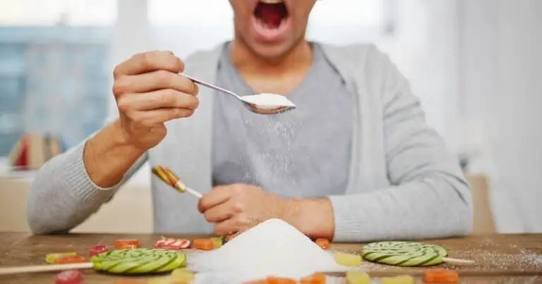 How to Stop Eating Sugar – a man eating a mound of sugar.