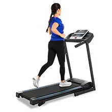 Home Gym Equipment - woman running on a TR150 Folding Treadmill