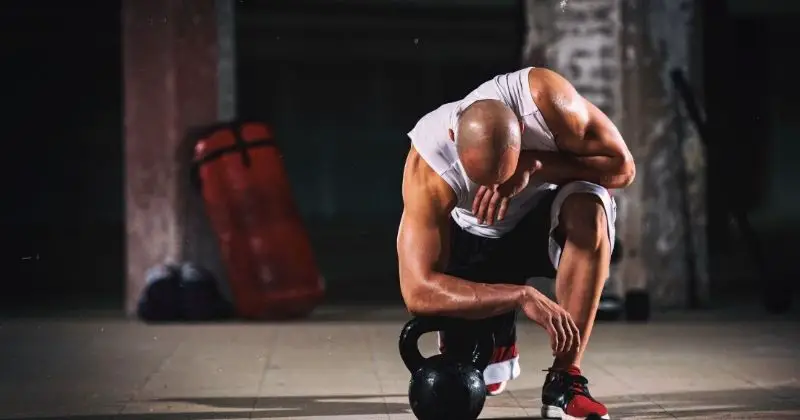 Workouts for Men over 40 – Man on his knee with a kettlebell