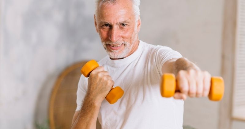 Home Workout Plan - Man using neoprene dumbbells 
