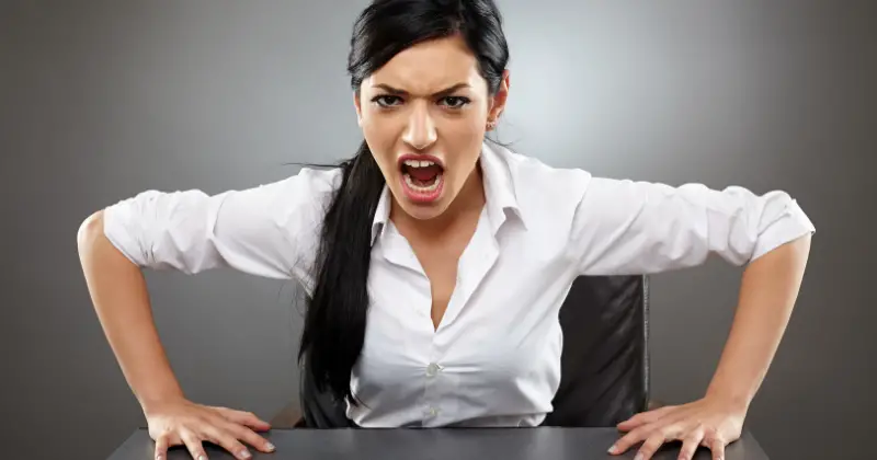 Trauma-related dissociation - Woman slamming her hands on a table